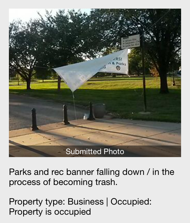 A banner falling down in a park.